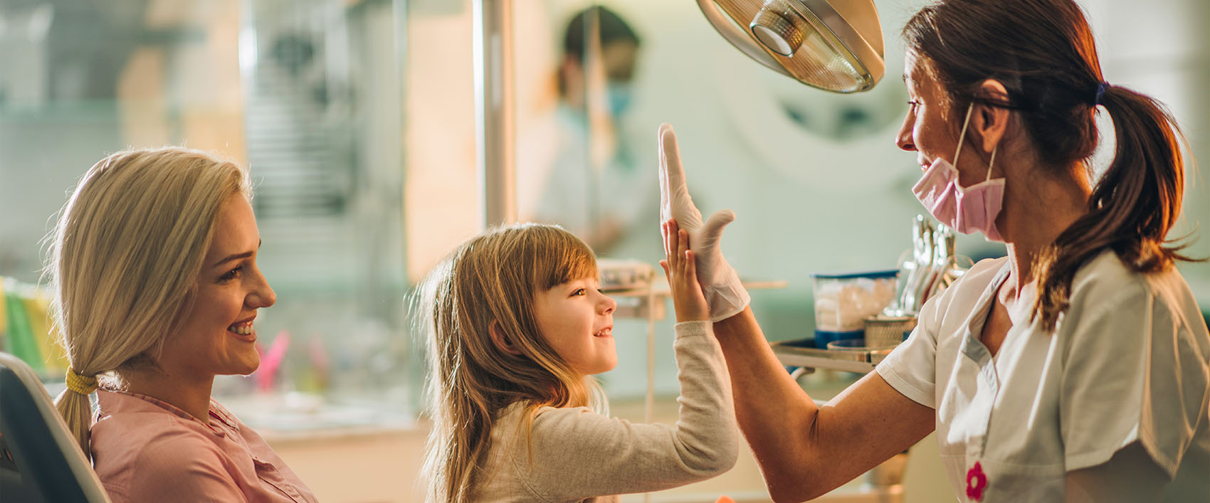 Young girl high fiving a dentist