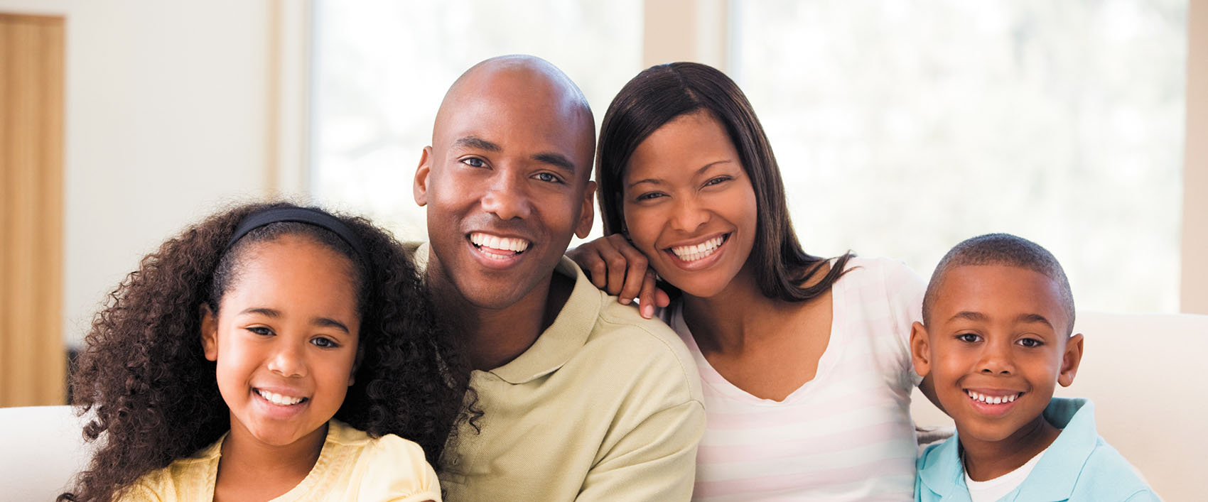 Smiling father, mother, and their two children