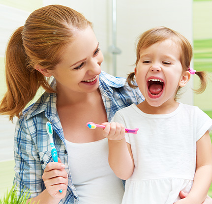 mother and daughter brushing teeth