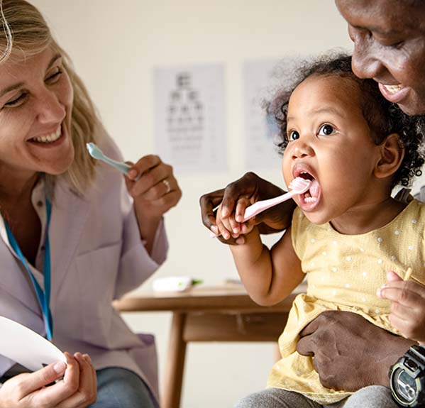 dentist with a child with toothbrush